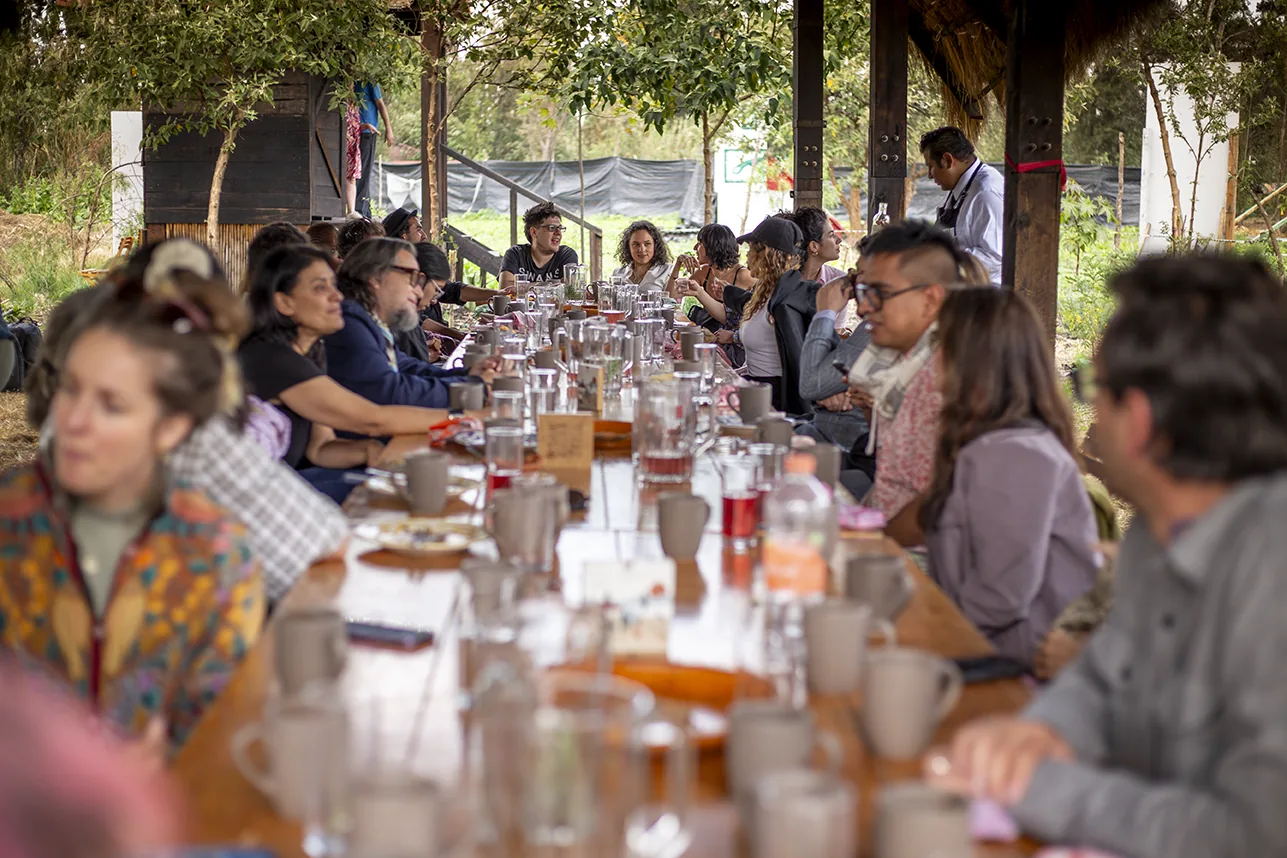Communal dinner under a palapa, Aki Aora 2025