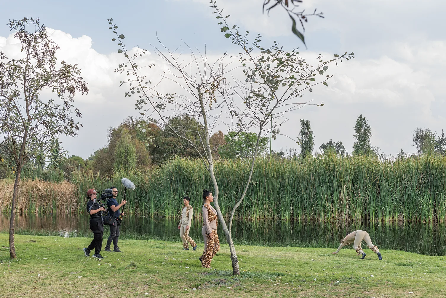 Camera crew filming performers in seed costumes, Aki Aora 2025