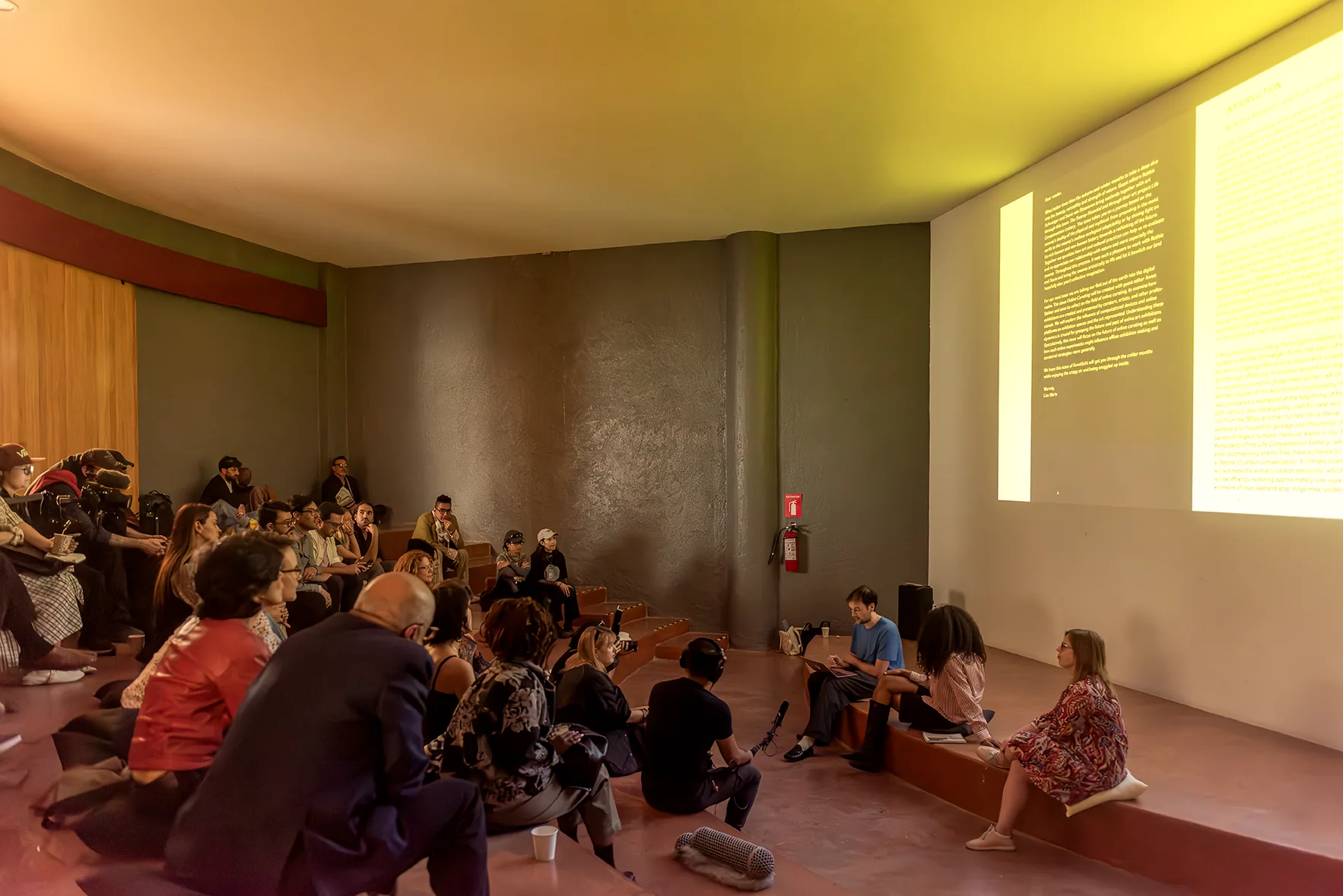 Panel discussion with projected text, Aki Aora 2025