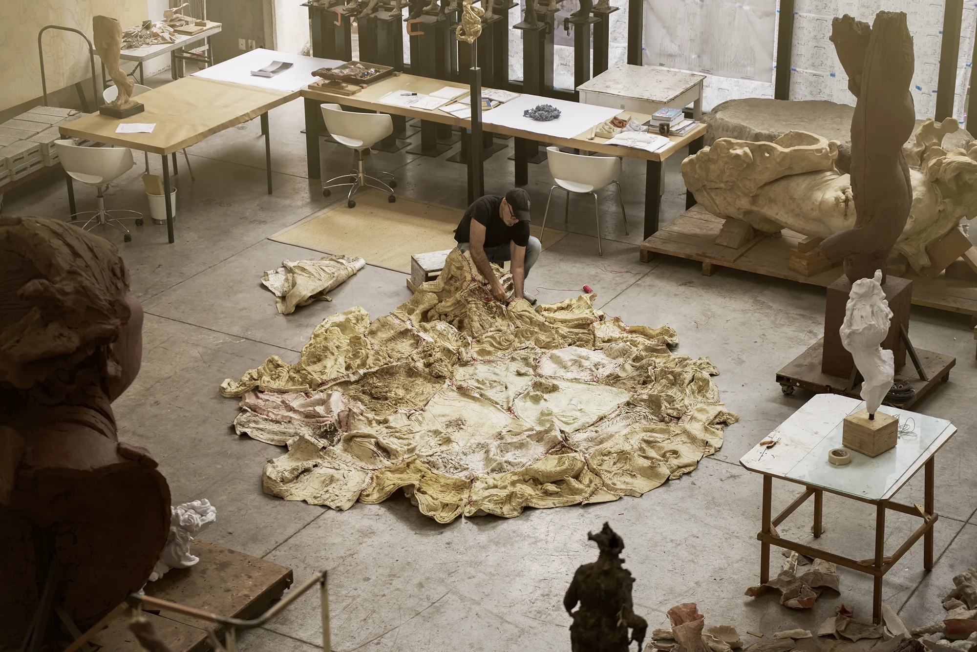 Javier Marín working on a large stitched clay piece in his studio