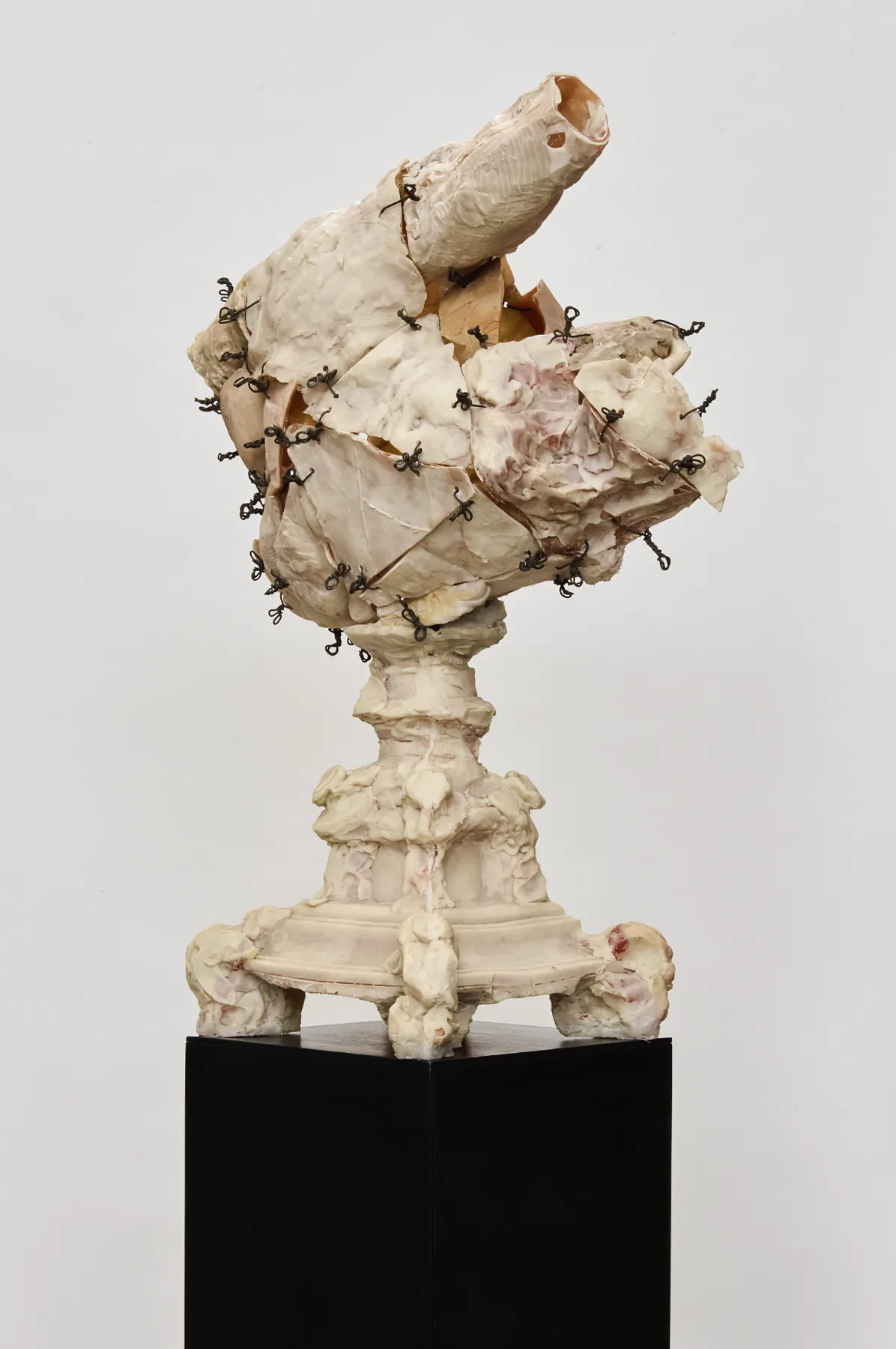 Wire-stitched sculpture on a pedestal, full view