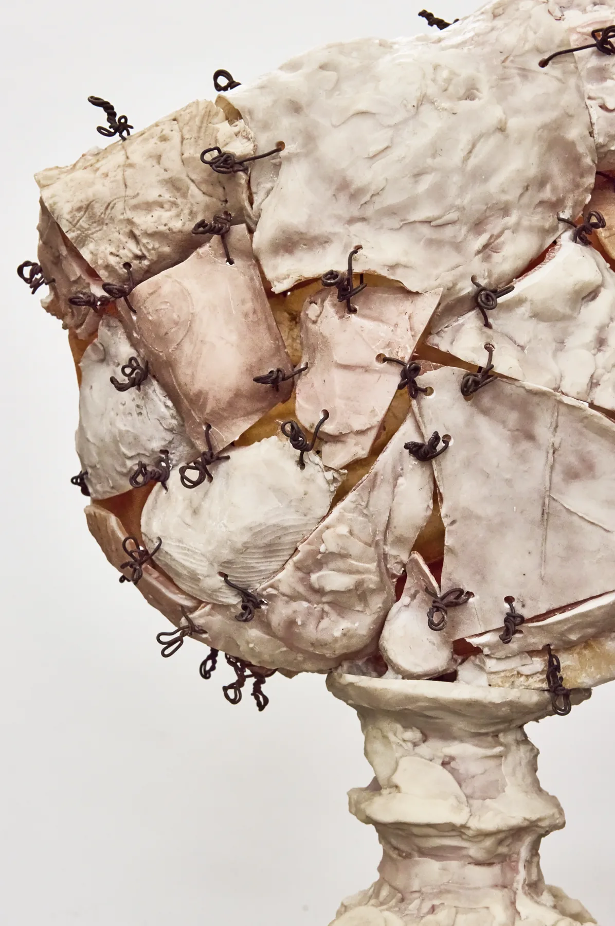 Close detail of wire-stitched sculpture head