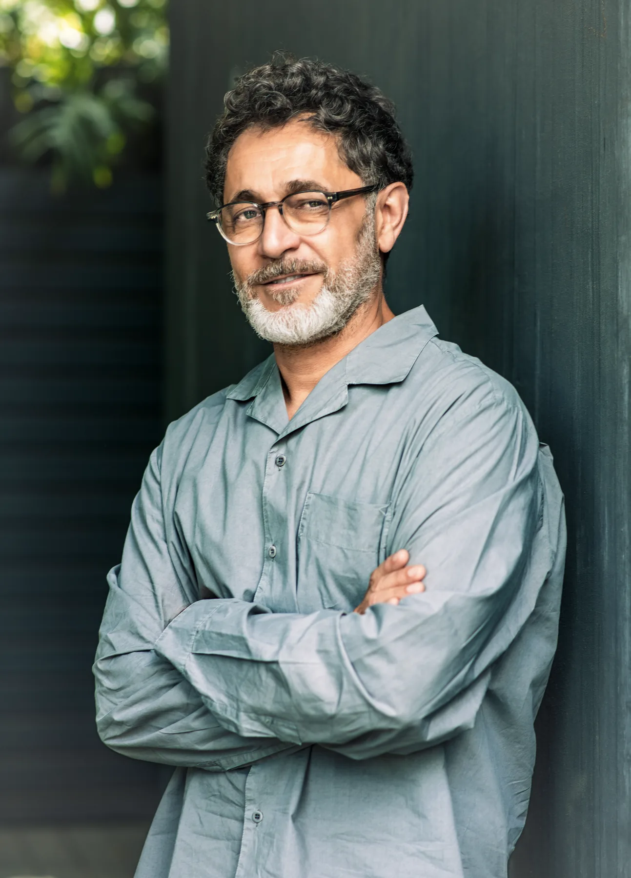 Portrait of a man, arms crossed, outdoors