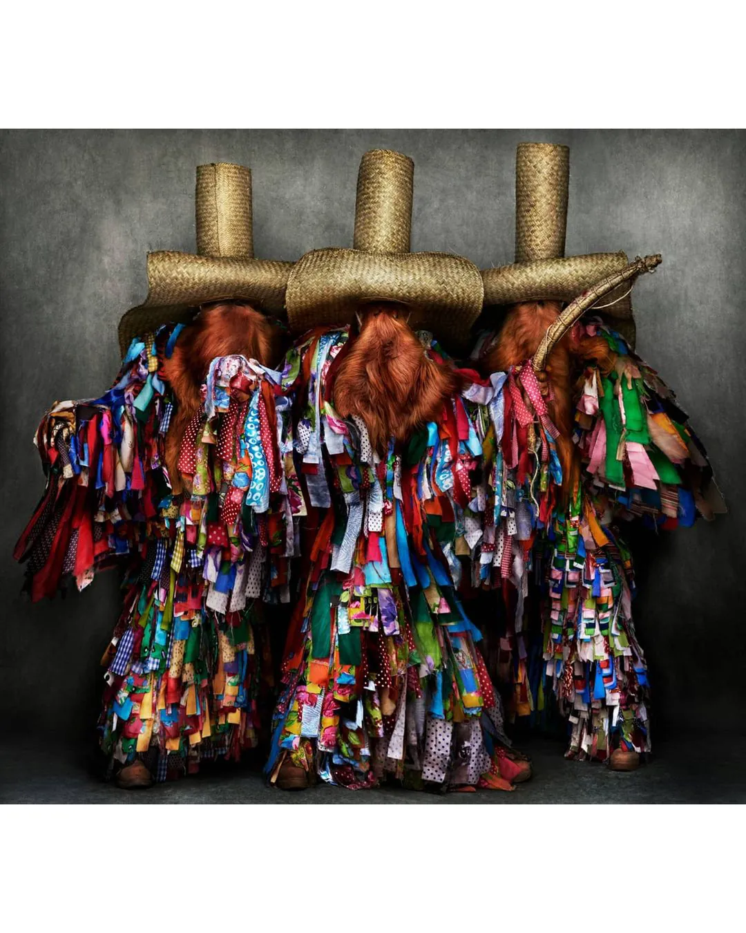 Three figures in traditional costume