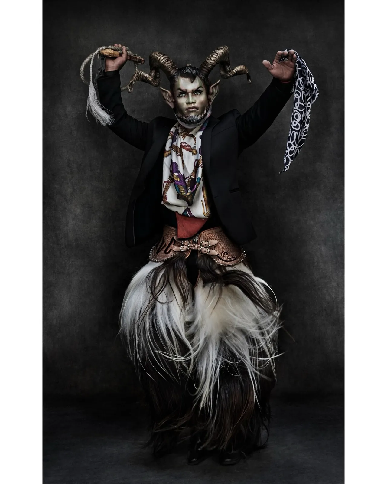 Horned masked figure with silk scarves
